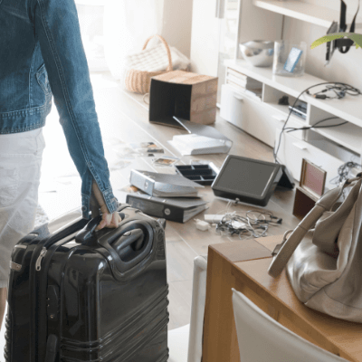 Female holidaymaker returning from holiday surveying the chaos to her home caused by a burglary